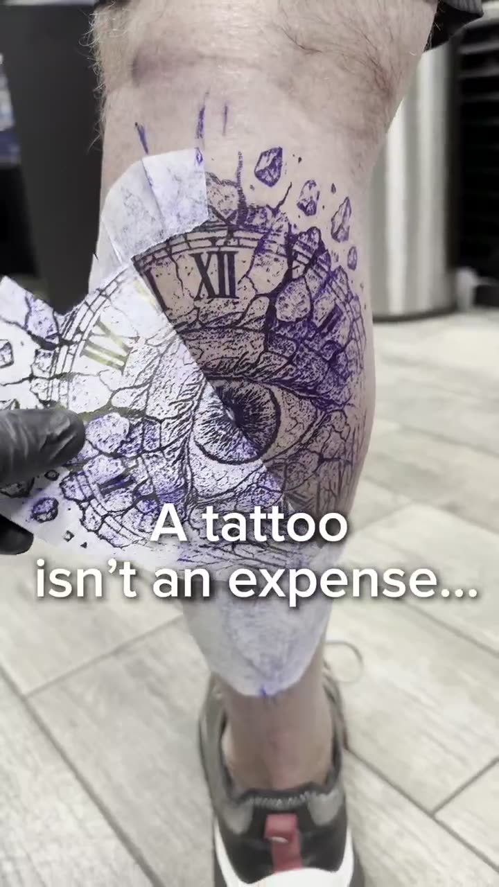 Video of a surrealist eye and clock tattoo on the lower leg