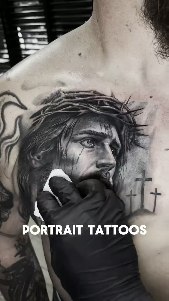 Video of a black and grey Christ portrait tattoo on the chest