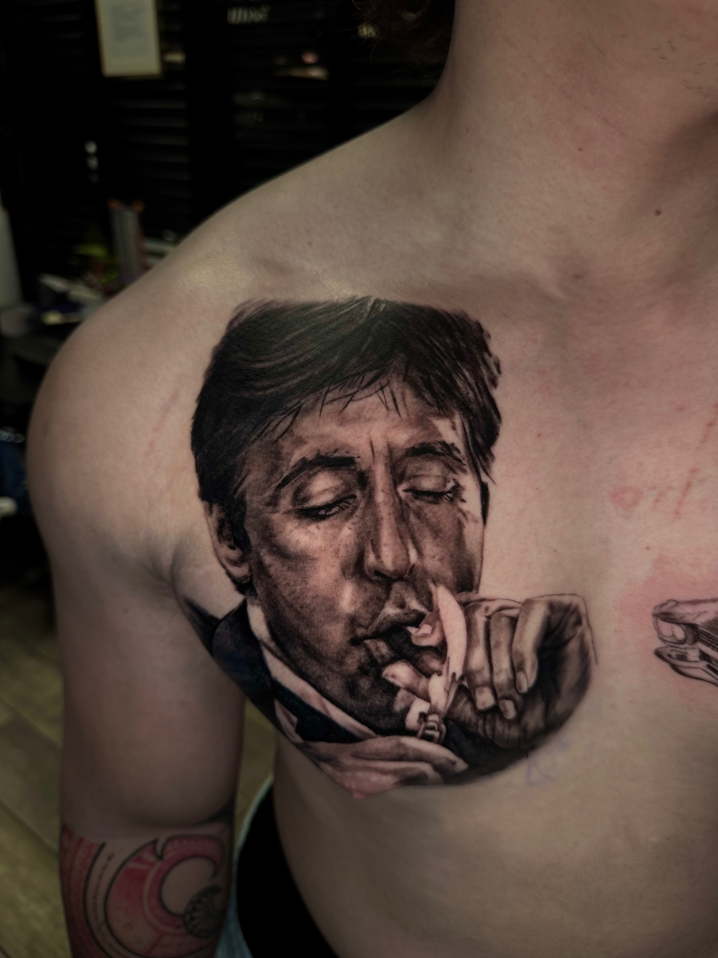 Black and grey portrait tattoo of Paul McCartney on the chest